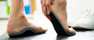 Close-up of feet using orthotic insoles, showing arch and heel support.